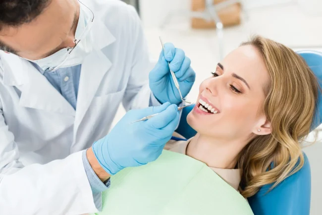 A woman at the dentist getting her teeth checked