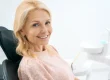 A woman seated on a dental chair