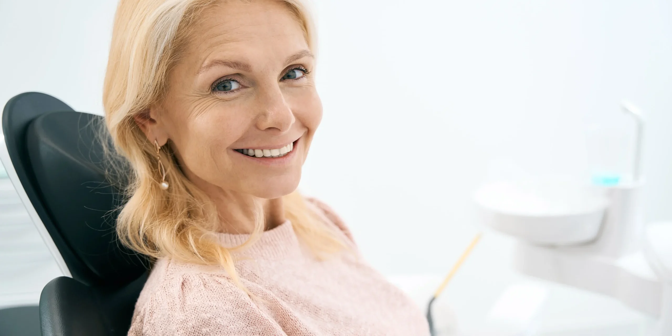 A woman seated on a dental chair