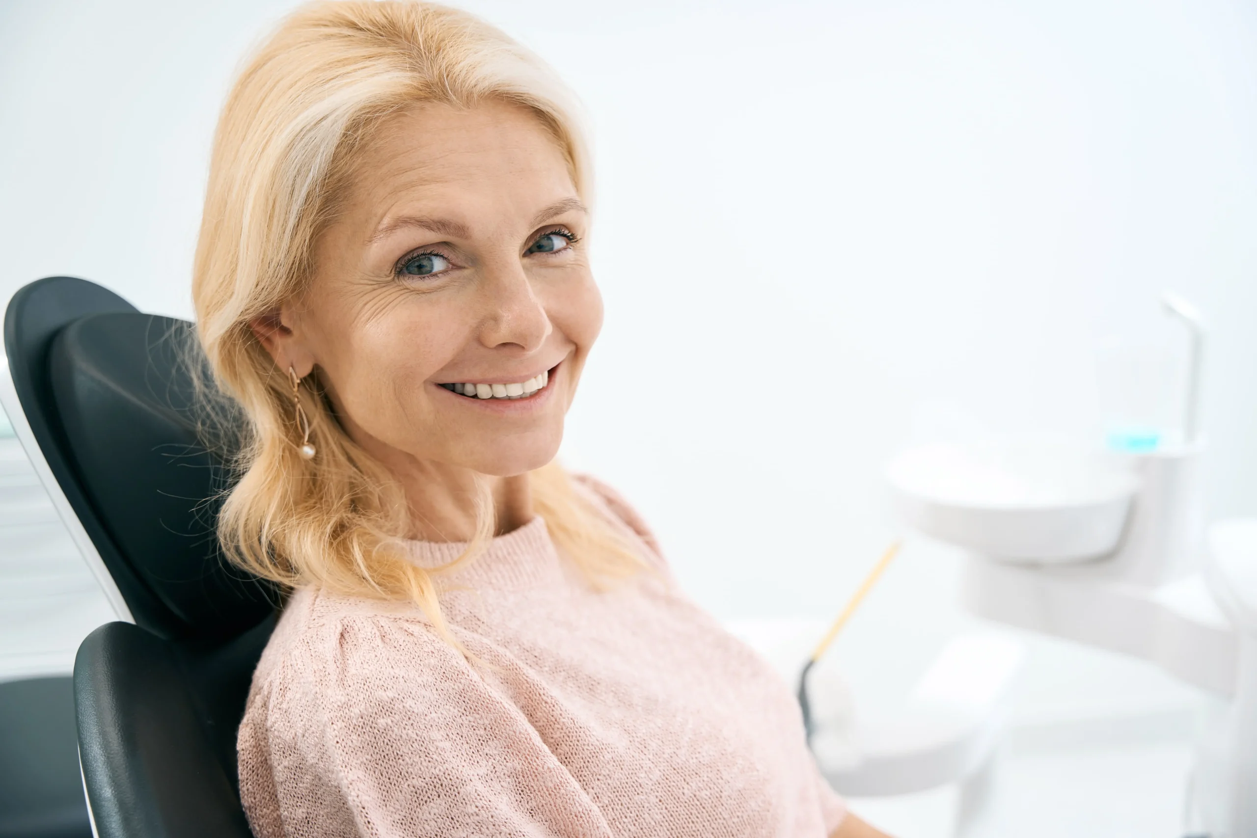 A woman seated on a dental chair