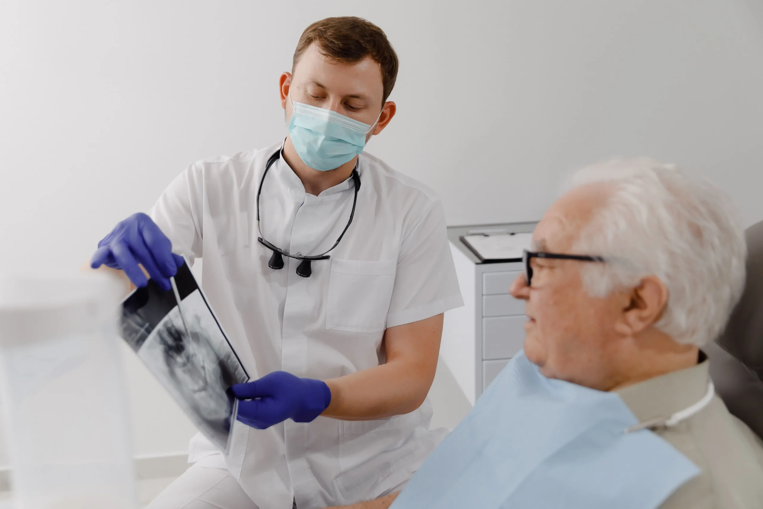 A dentist shows his patient an x-ray