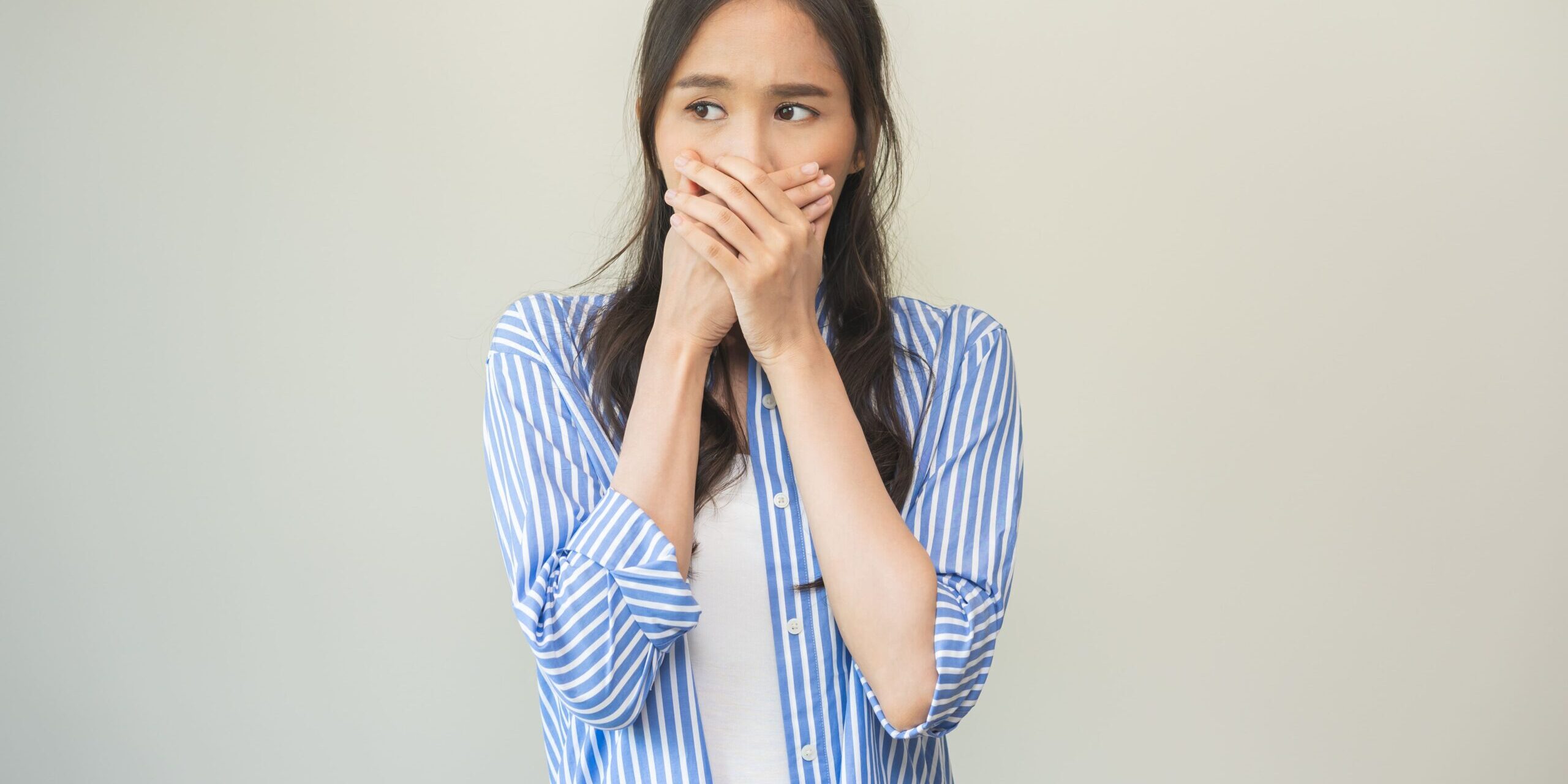 Bad Breath – Ashgrove woman with bad breath covering her mouth