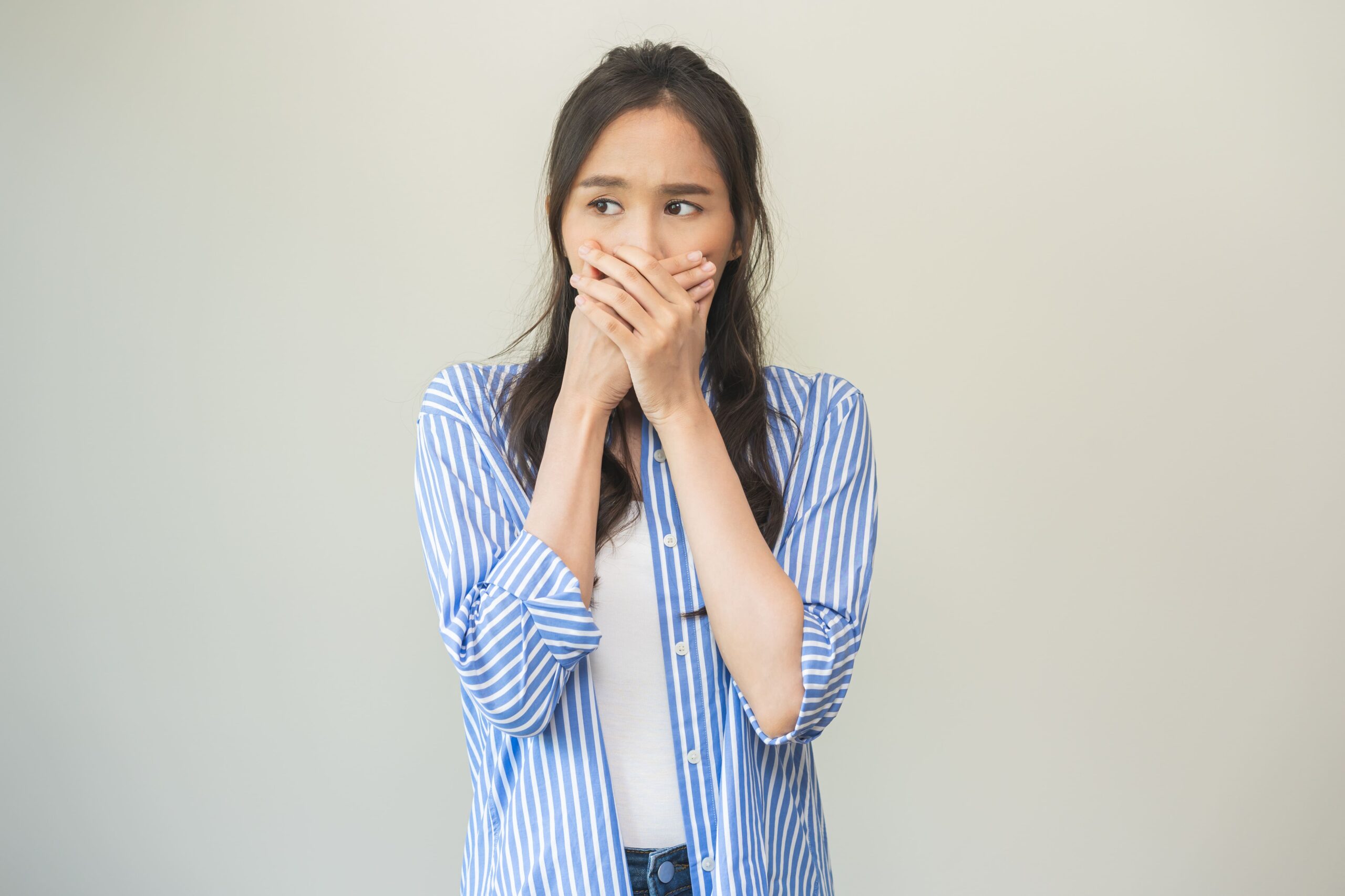 Bad Breath – Ashgrove woman with bad breath covering her mouth